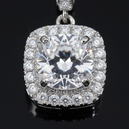 Close-up detail of cushion-cut center stone, halo, and lever-back