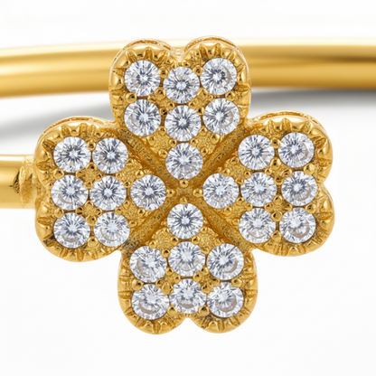 Close-up detail of diamond-pavé clover and metal texture - version 2