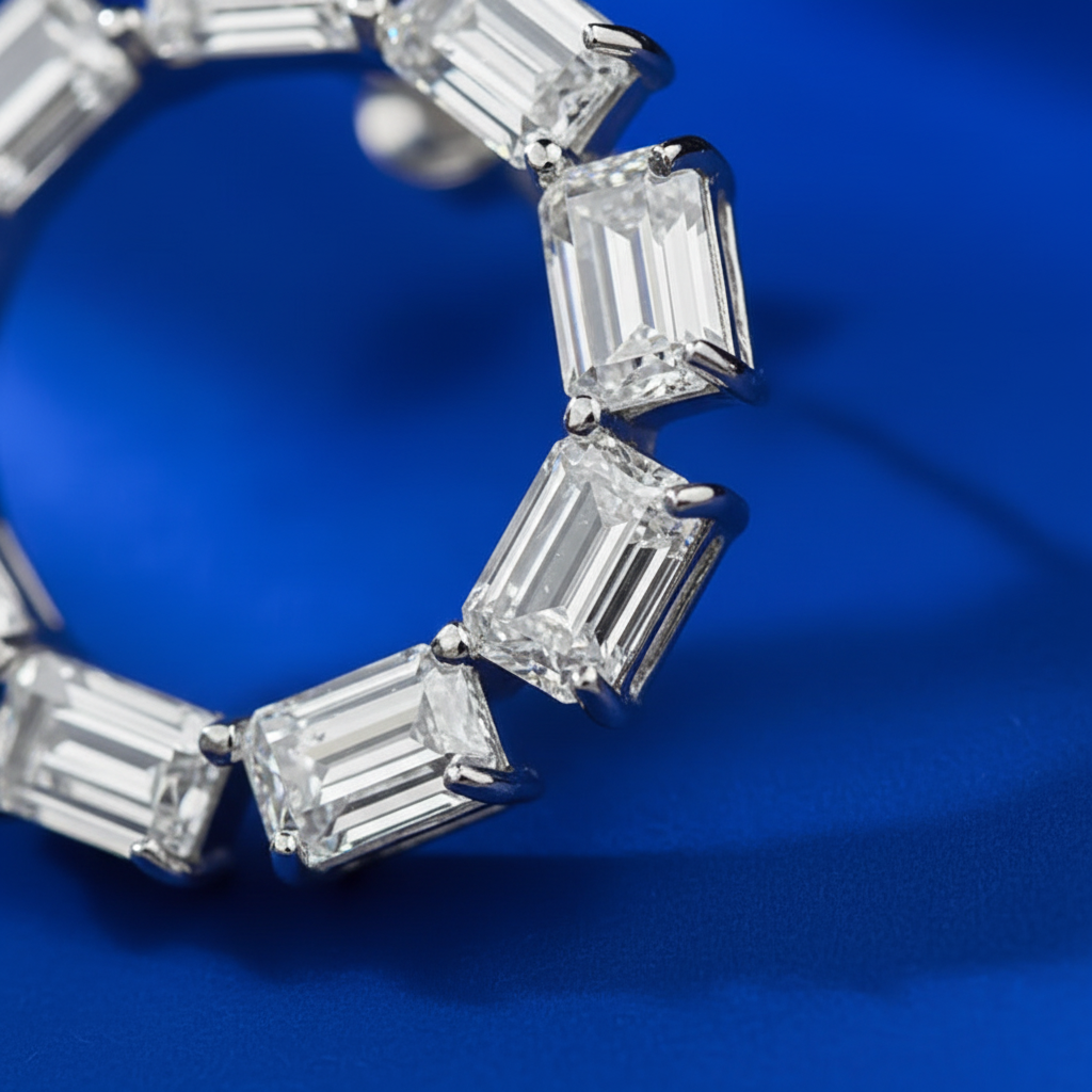 Close-up detail of emerald-cut diamond geometric hoop