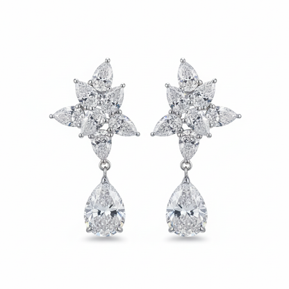 Diamond flower cluster drop earrings on white background