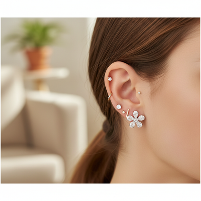 Diamond flower stud earrings styled with other stud earrings showing ear stacking
