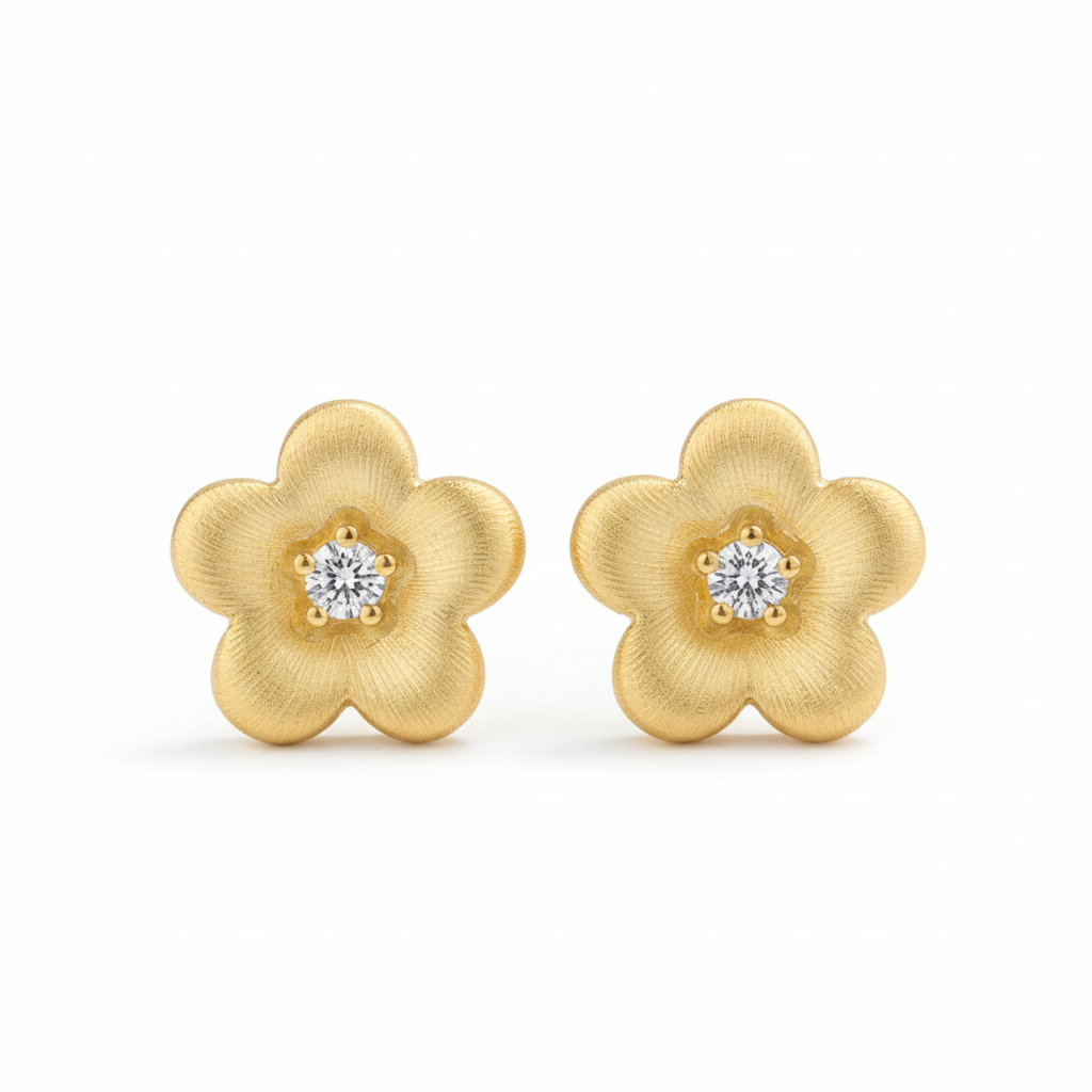 Gold brushed flower stud earrings on white background