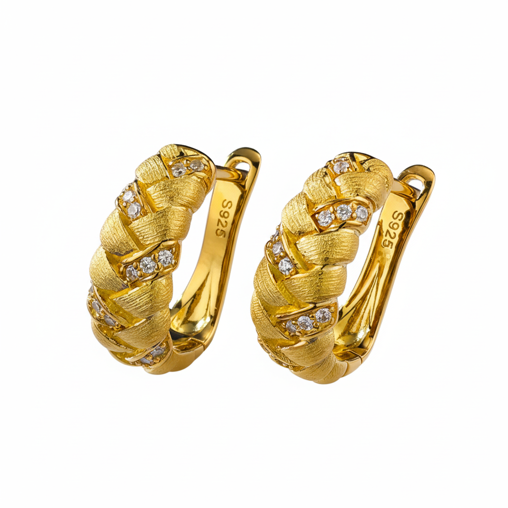Gold textured hoop earrings with diamond accents on white background