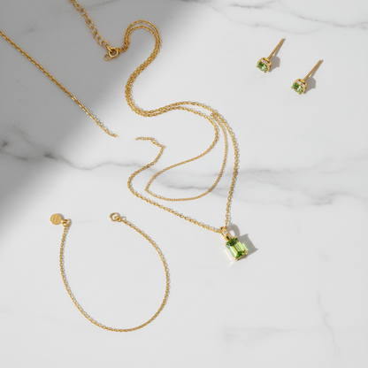 Green crystal pendant flat lay styling