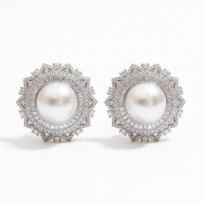 Pearl and diamond halo stud earrings on white background