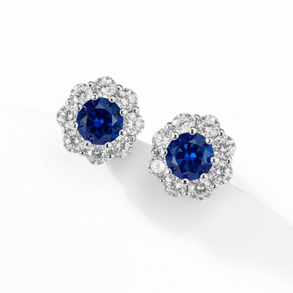 Sapphire blue diamond halo stud earrings on white background