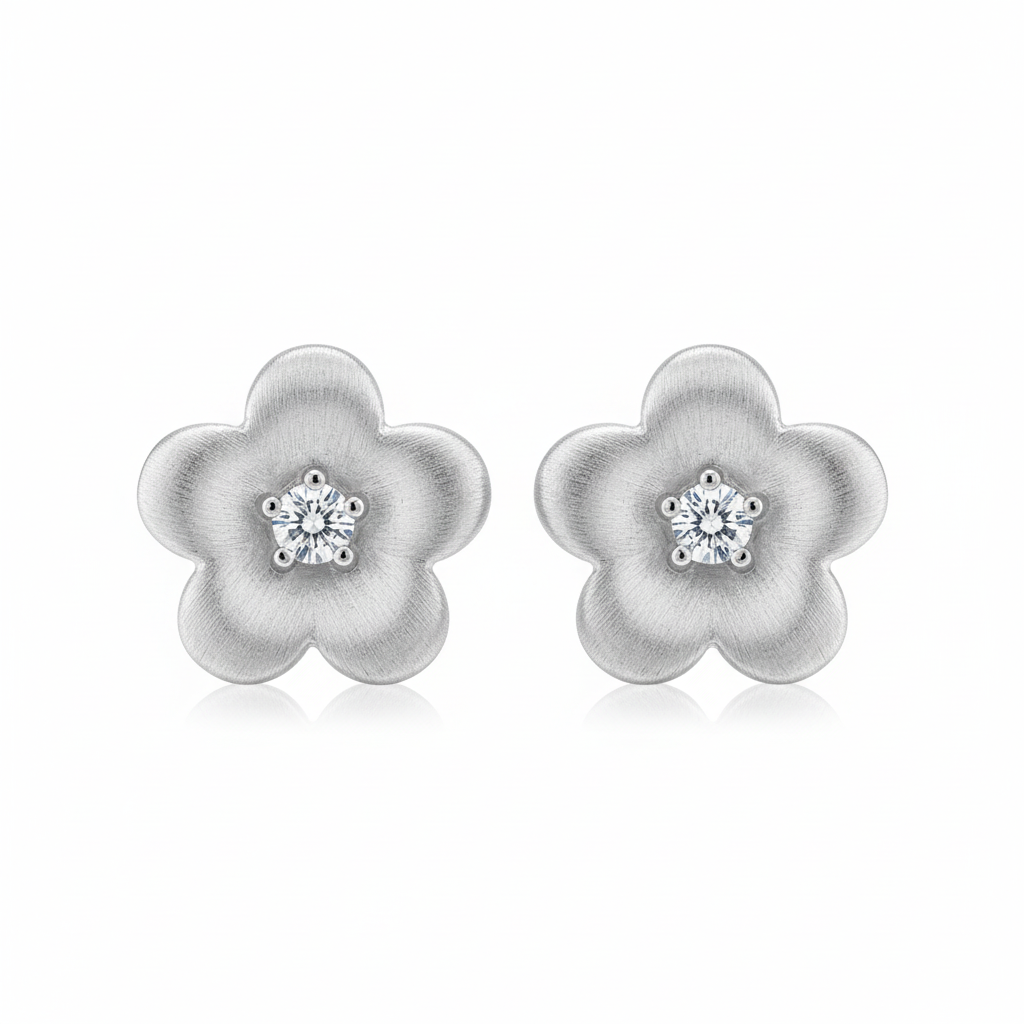 Silver brushed flower stud earrings on white background