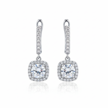 Silver cushion-cut halo drop earrings on white background