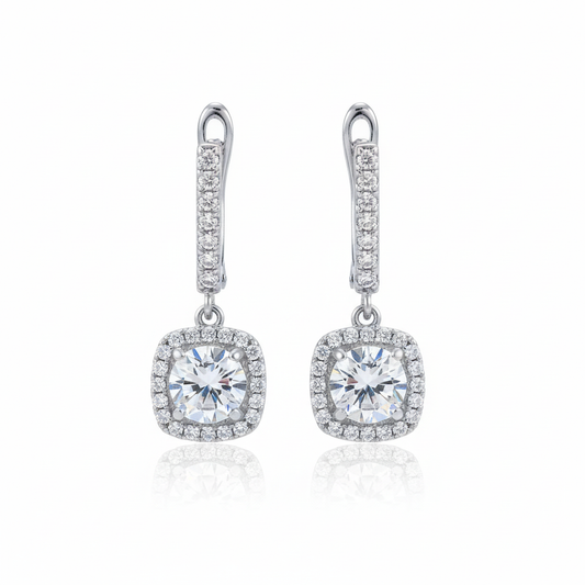 Silver cushion-cut halo drop earrings on white background