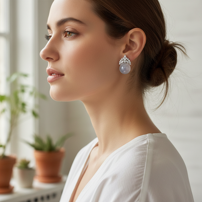 Woman wearing semi-transparent white gemstone and diamond crown earrings - lifestyle shot 1