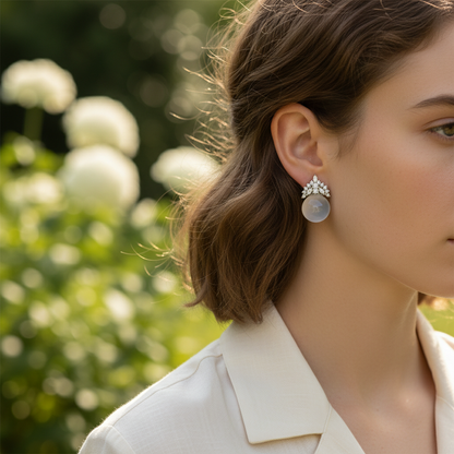 Woman wearing semi-transparent white gemstone and diamond crown earrings - lifestyle shot 2