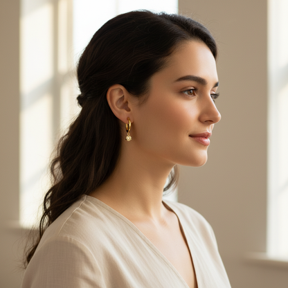 Woman wearing small delicate gold hoop earrings with yellow diamond drops - lifestyle shot 1
