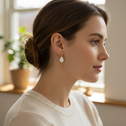 Woman wearing small delicate pear-shaped diamond drop earrings - lifestyle shot 1